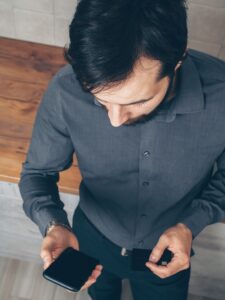 Person using a smartphone and credit card for an online transaction